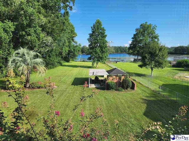 surrounding community with a gazebo, a water view, and a yard