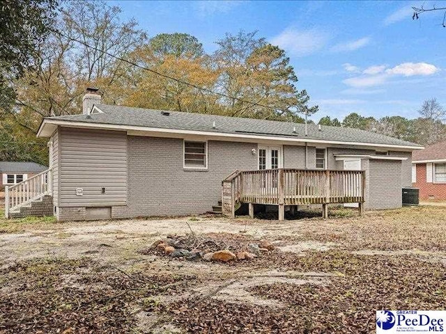 back of house with a wooden deck and cooling unit