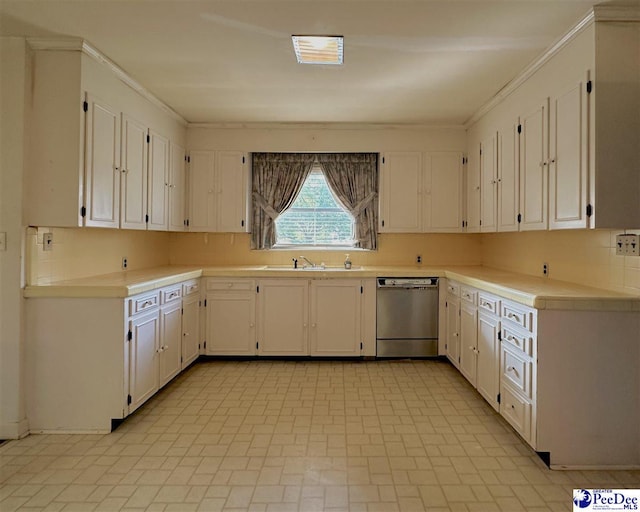 kitchen featuring tasteful backsplash, sink, stainless steel dishwasher, and white cabinets