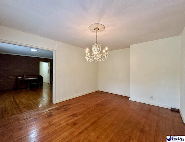 unfurnished dining area with a notable chandelier and dark hardwood / wood-style flooring