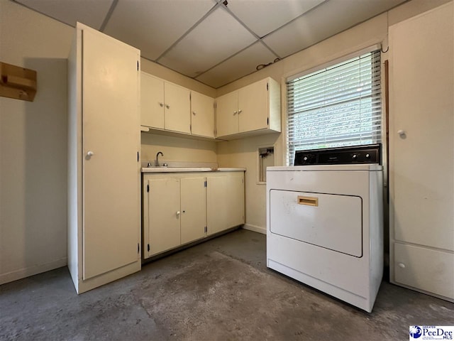 laundry room featuring washer / clothes dryer, sink, and cabinets