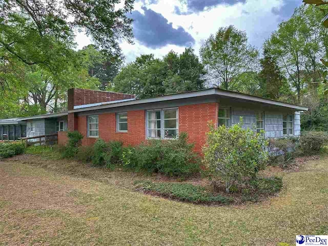 view of side of property with a yard