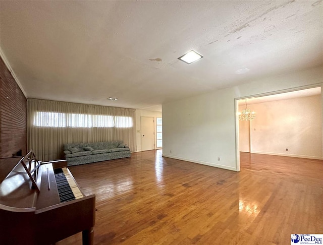 living room with hardwood / wood-style floors and a notable chandelier