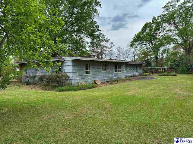 rear view of property with a yard