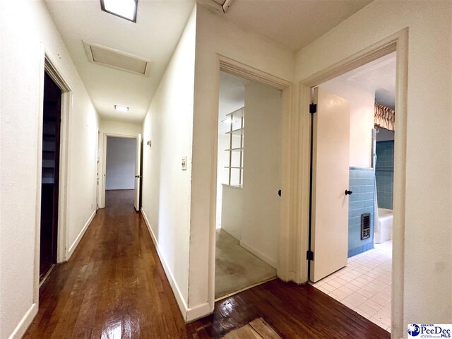 hall with hardwood / wood-style flooring