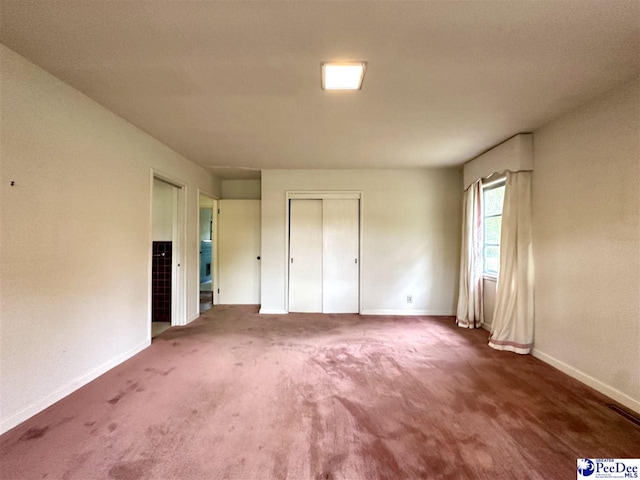 unfurnished bedroom with dark carpet