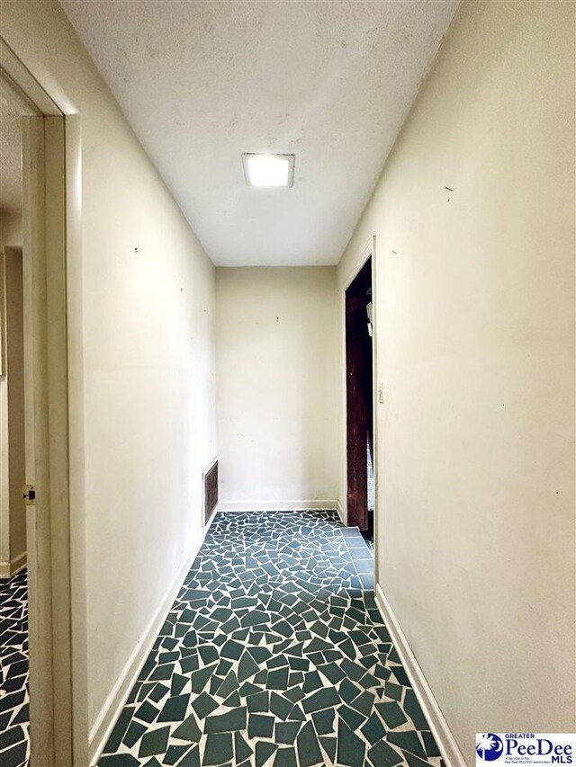 corridor with a textured ceiling