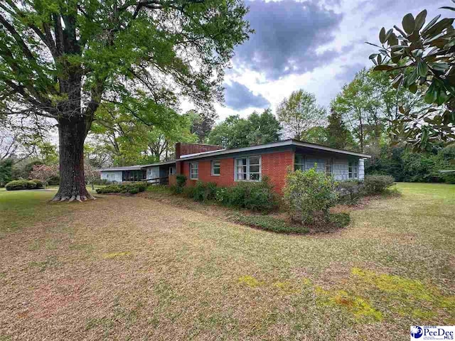 view of side of home featuring a lawn