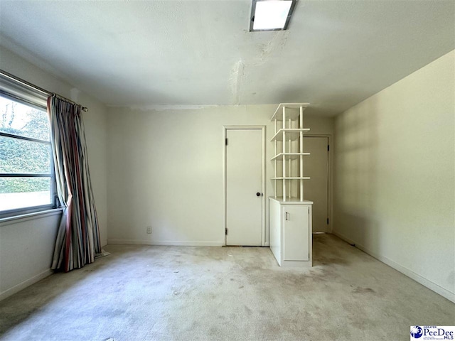 empty room featuring light carpet