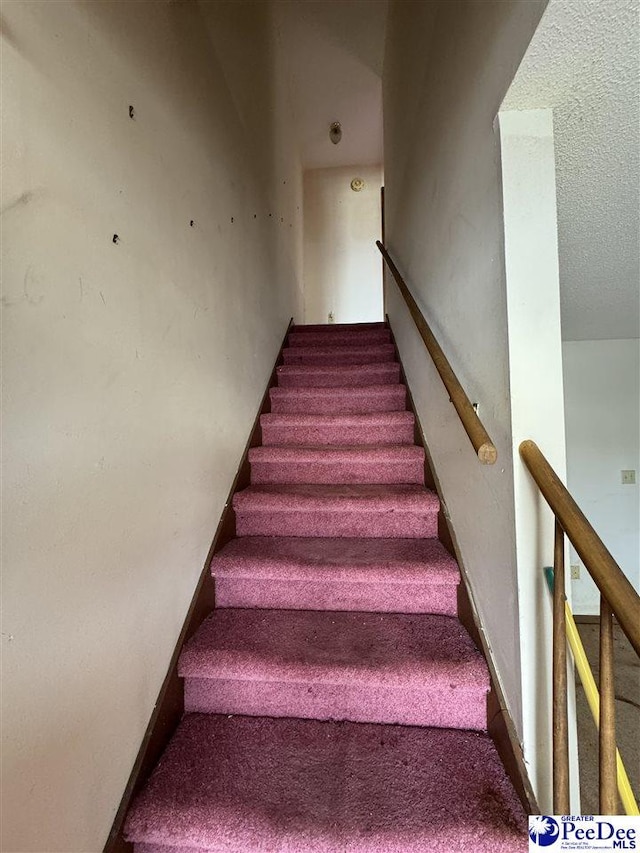 stairs featuring baseboards and carpet floors