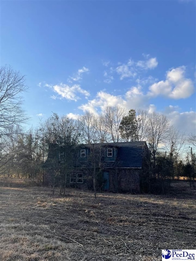 view of front facade with a rural view