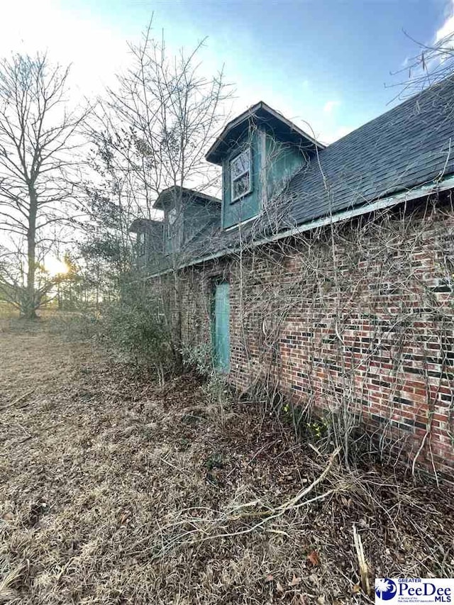 view of side of property with brick siding