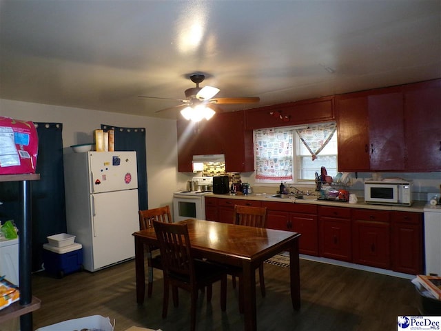 kitchen with dark hardwood / wood-style flooring, sink, ceiling fan, and white appliances