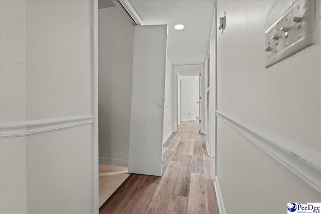 701 Coventry Ln Unit B7, Lane, Florence, SC 29501 - hallway with wood finished floors, a textured ceiling, and baseboards