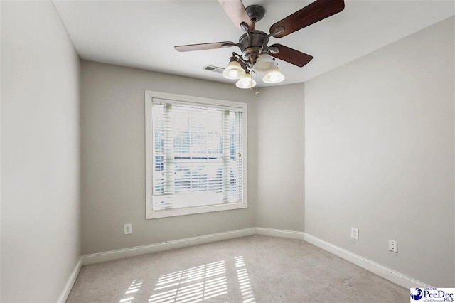 unfurnished room with light colored carpet, visible vents, ceiling fan, and baseboards