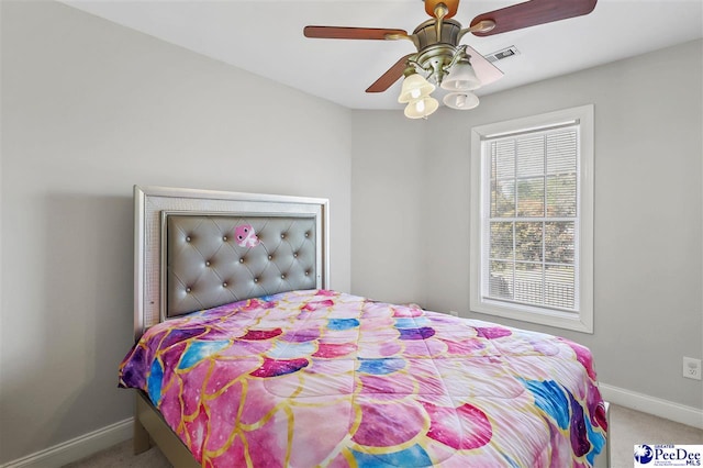 bedroom with carpet floors, visible vents, ceiling fan, and baseboards