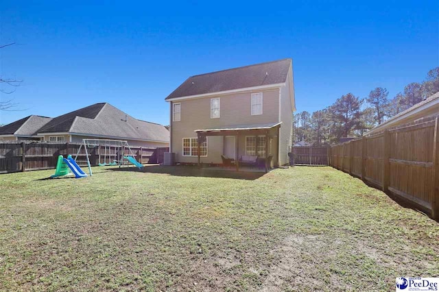 rear view of property featuring a fenced backyard, cooling unit, a playground, and a yard