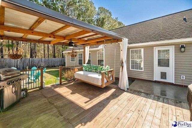 wooden deck featuring fence and a ceiling fan