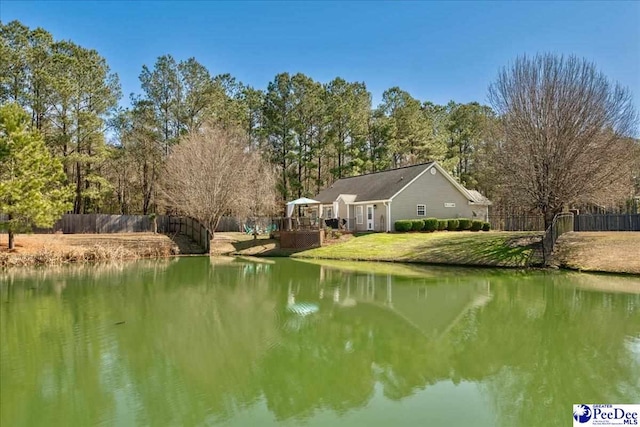 view of water feature with fence and a gazebo