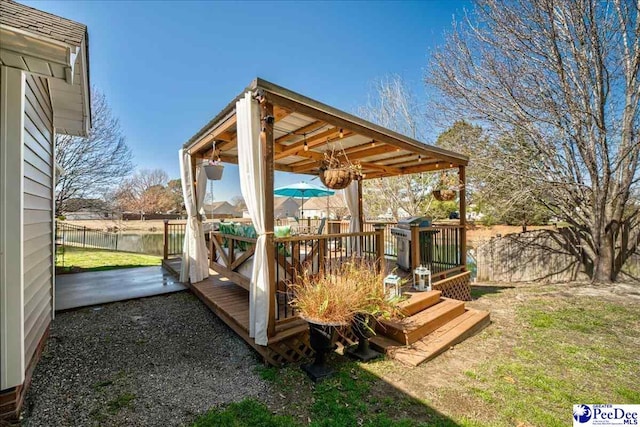 wooden terrace featuring a fenced backyard