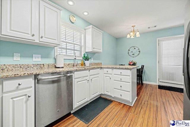 kitchen with light wood-style flooring, a peninsula, white cabinets, light stone countertops, and dishwasher