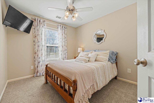 bedroom featuring visible vents, light carpet, and baseboards