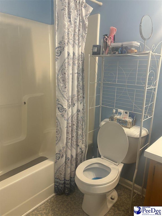 bathroom featuring shower / tub combo and toilet