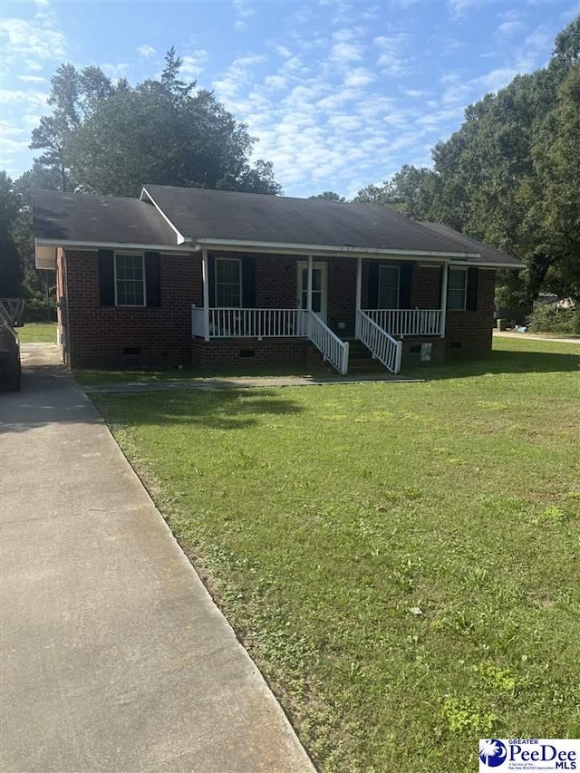 single story home featuring covered porch and a front yard