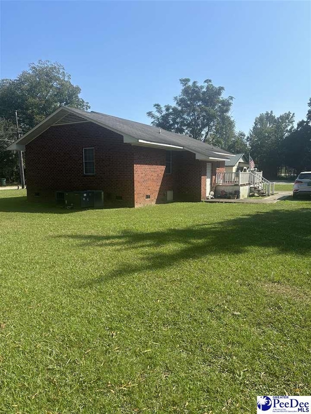 view of home's exterior with a yard