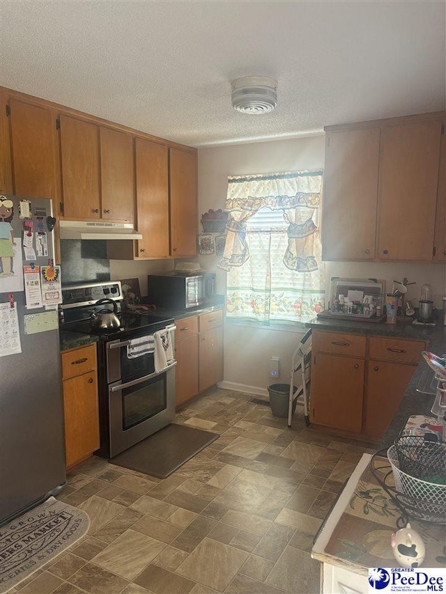 kitchen featuring a textured ceiling and appliances with stainless steel finishes