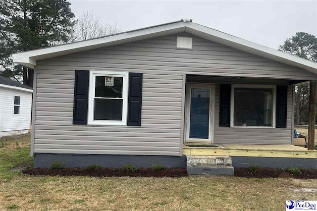 bungalow-style home with a front yard