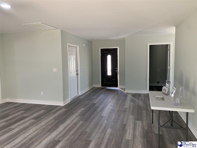 foyer entrance with visible vents, baseboards, and dark wood finished floors