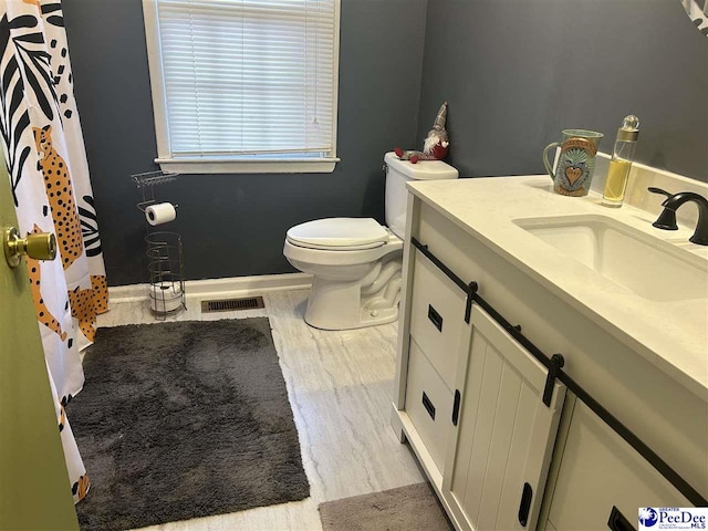 bathroom featuring vanity, hardwood / wood-style floors, and toilet