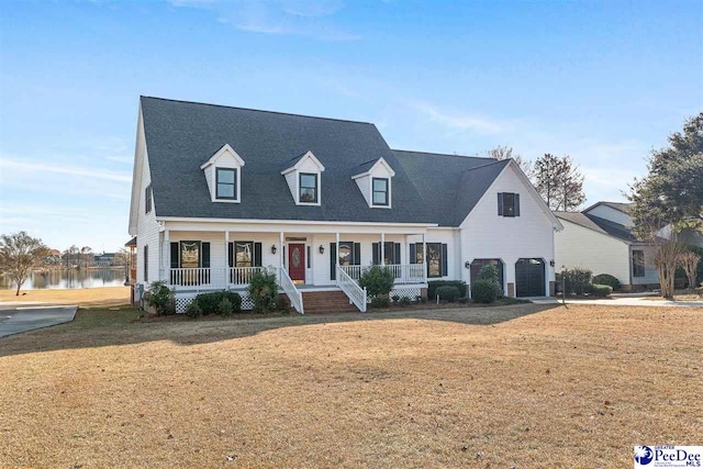 cape cod house featuring a garage, covered porch, and a front lawn