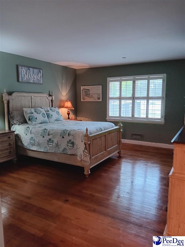 bedroom featuring dark hardwood / wood-style flooring