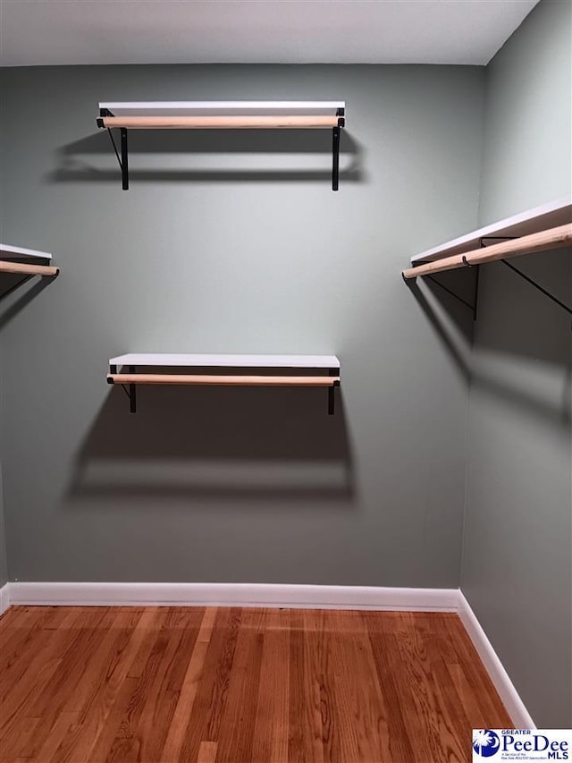 spacious closet featuring hardwood / wood-style floors