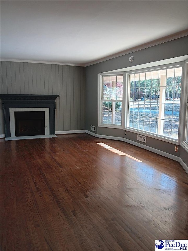 unfurnished living room with wood-type flooring and a wealth of natural light