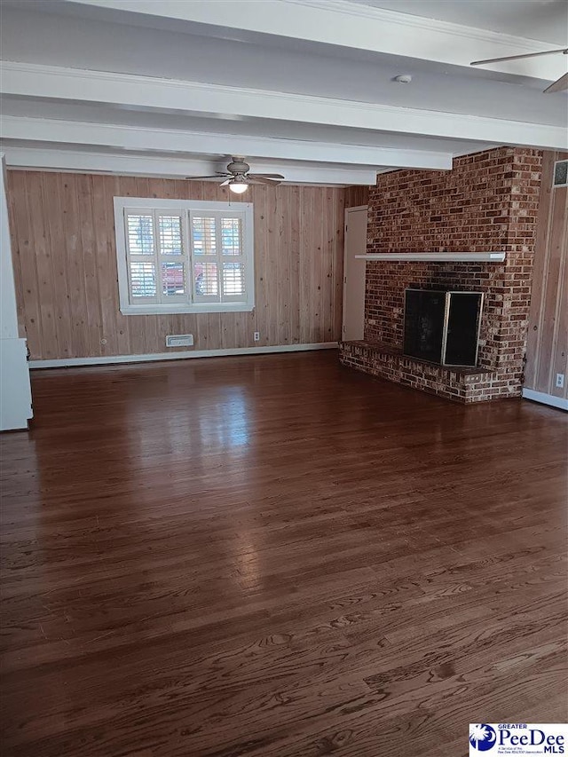 unfurnished living room featuring dark wood-type flooring, ceiling fan, beam ceiling, and a fireplace