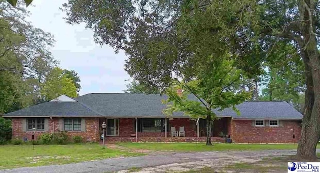 ranch-style home featuring a front yard