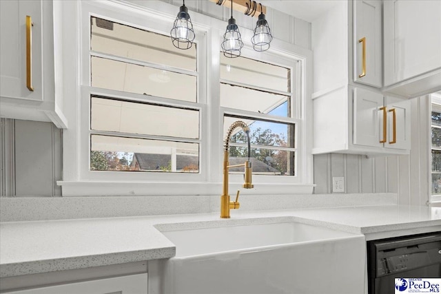 kitchen featuring white cabinetry, a chandelier, dishwasher, and sink