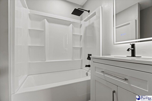 bathroom featuring vanity and  shower combination