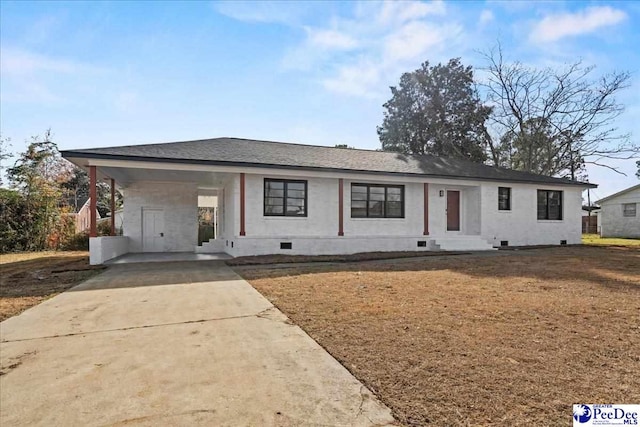 ranch-style home featuring a carport and a front yard