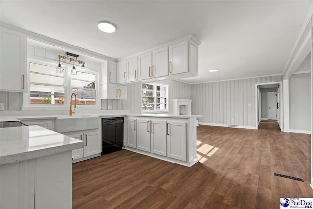 kitchen featuring black dishwasher, white cabinets, light stone counters, kitchen peninsula, and crown molding