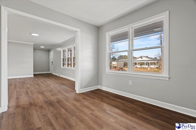 unfurnished room featuring crown molding and wood-type flooring