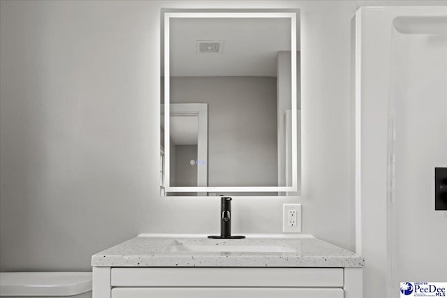 bathroom with vanity and toilet