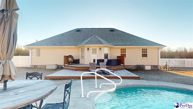 view of pool with fence, a deck, cooling unit, and a fenced in pool