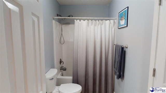 bathroom featuring shower / bathtub combination with curtain and toilet