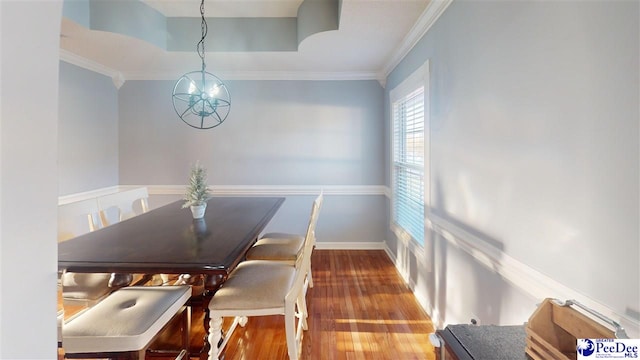 dining area featuring ornamental molding, wood finished floors, and baseboards