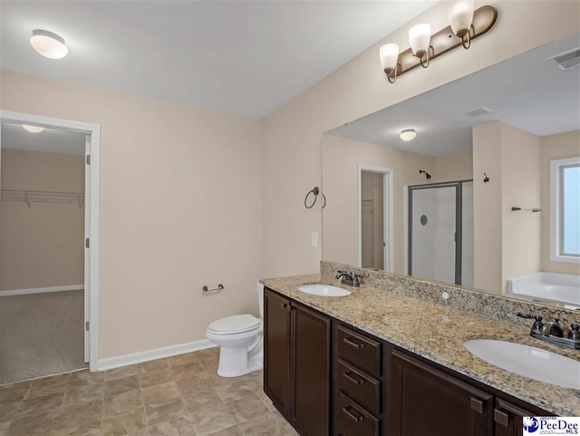 full bathroom featuring toilet, vanity, and shower with separate bathtub