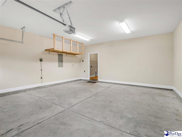 garage with a garage door opener and electric panel